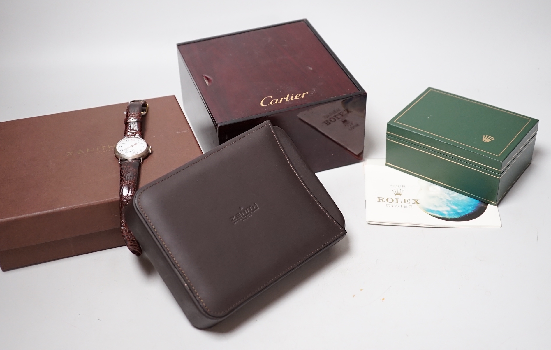 A Rolex watch box, Zenith watch box, Cartier watch box and a gentleman's early 20th century silver manual wind wrist watch.